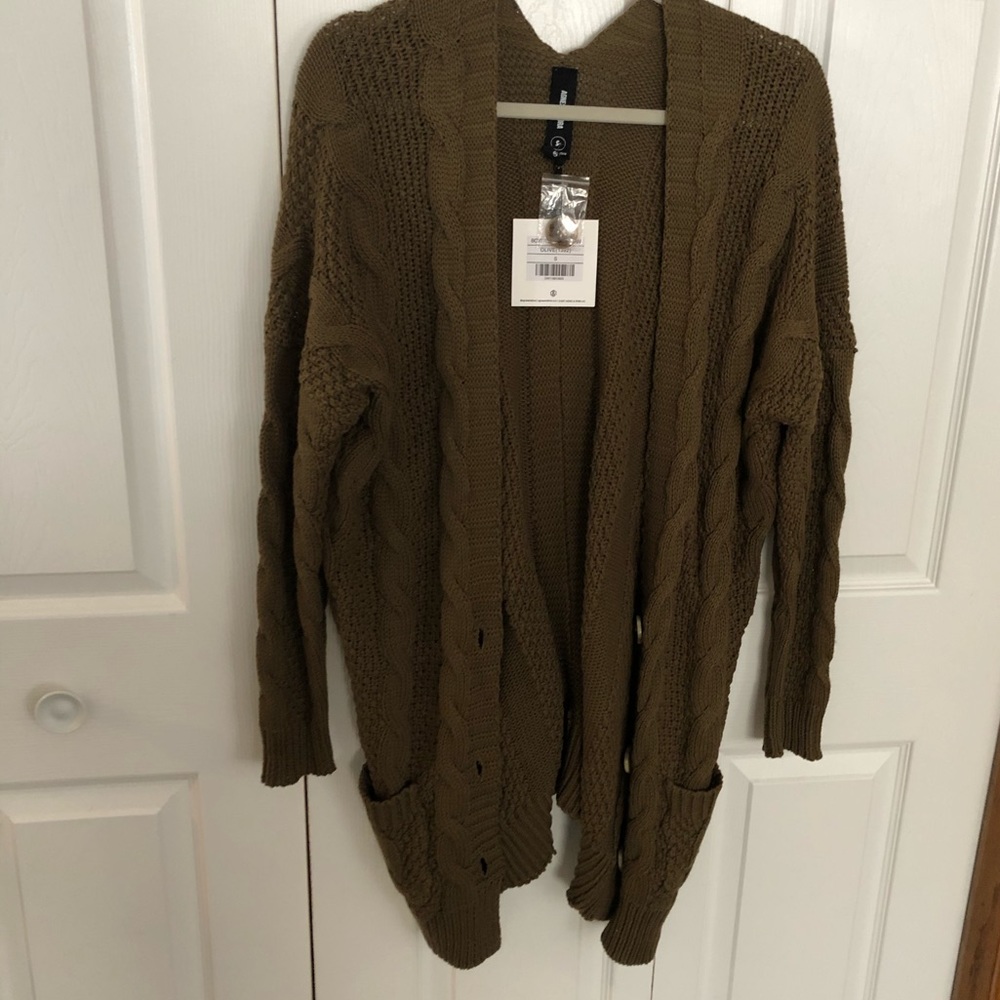 Dark olive green cable knit sweater.